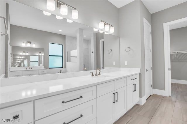 bathroom featuring vanity, tiled shower, and tile patterned floors