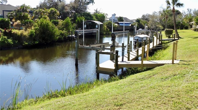 view of dock featuring a yard and a water view