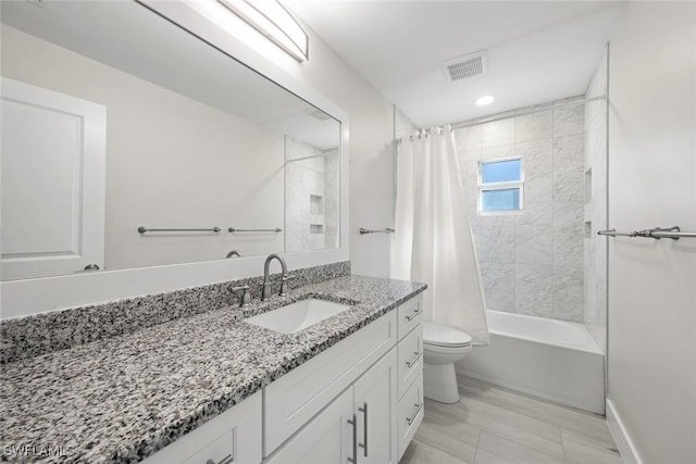 full bath with toilet, vanity, shower / bath combo, and baseboards