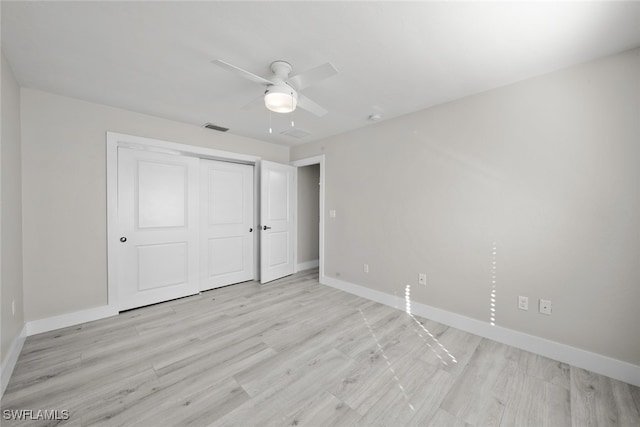 unfurnished bedroom featuring light hardwood / wood-style floors, ceiling fan, and a closet