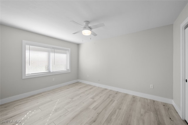 empty room featuring light wood-type flooring and ceiling fan