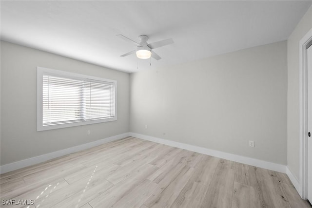 empty room with wood finished floors, ceiling fan, and baseboards