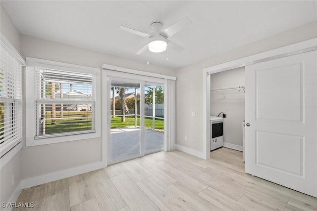 unfurnished bedroom featuring access to outside, baseboards, light wood-type flooring, and a ceiling fan