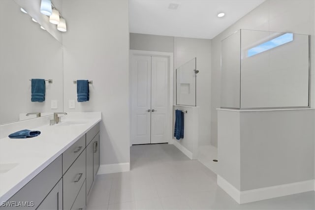 bathroom featuring vanity, tile patterned floors, and a shower