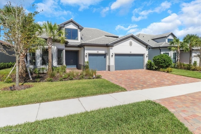 view of front of home with a front yard and a garage