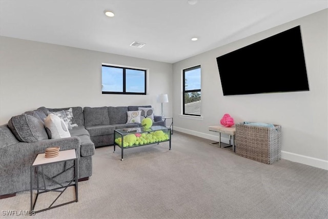 living area featuring recessed lighting, light carpet, visible vents, and baseboards