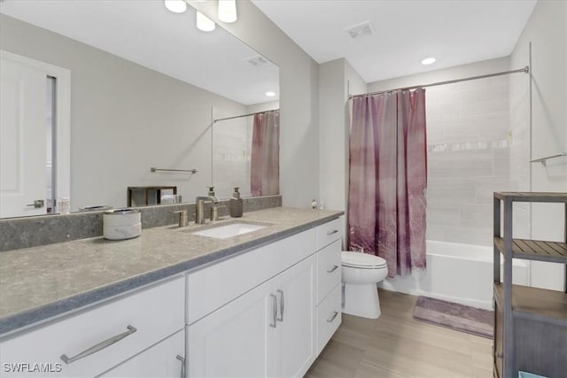 full bathroom featuring shower / tub combo, visible vents, vanity, and toilet