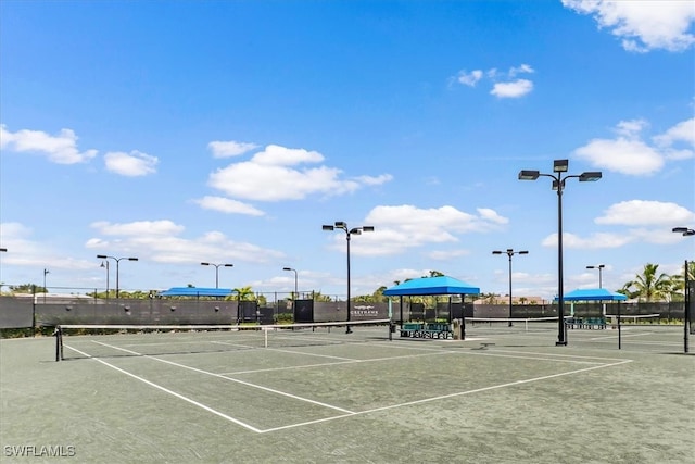 view of tennis court featuring fence