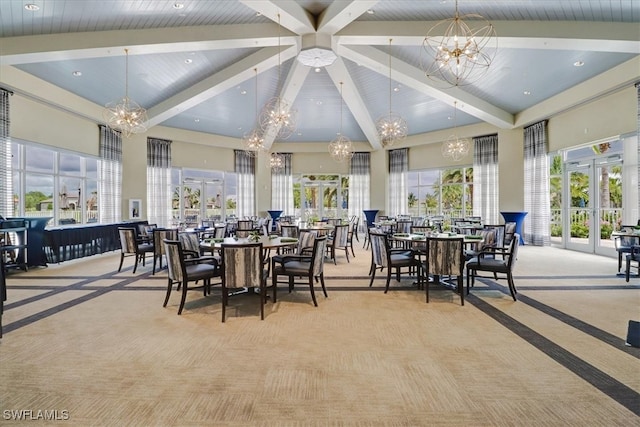 dining area with french doors, beam ceiling, light colored carpet, an inviting chandelier, and high vaulted ceiling