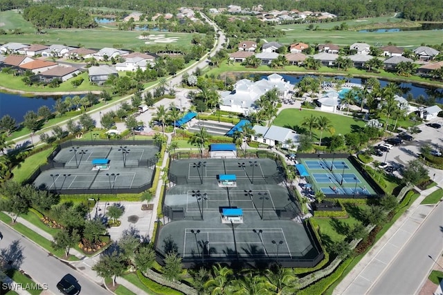 birds eye view of property with a water view, a residential view, and golf course view