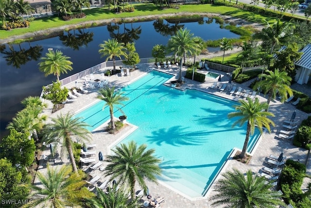 view of swimming pool featuring a patio and a water view