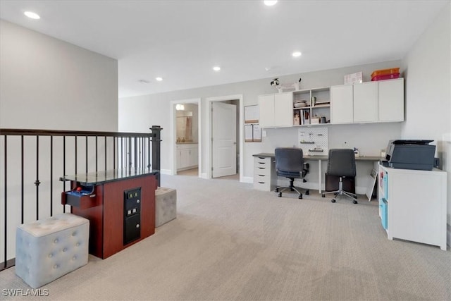 home office featuring light carpet, built in desk, and recessed lighting