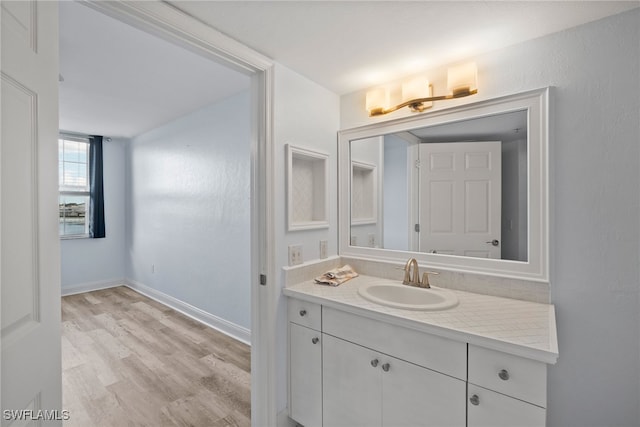 bathroom with vanity and wood-type flooring