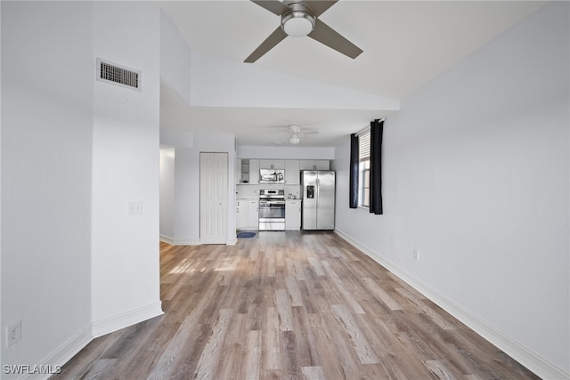 unfurnished living room featuring ceiling fan, light hardwood / wood-style flooring, and vaulted ceiling