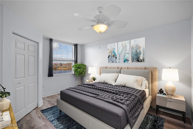 bedroom featuring hardwood / wood-style floors, ceiling fan, and a closet