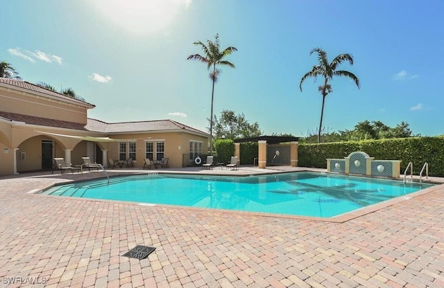 view of swimming pool with a patio area