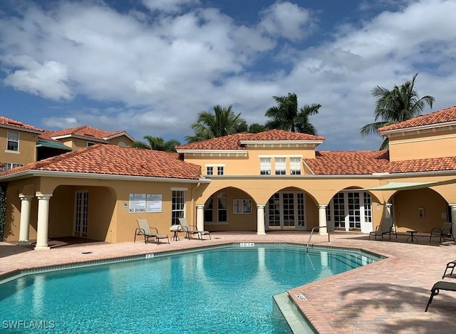 rear view of house with a patio and a community pool