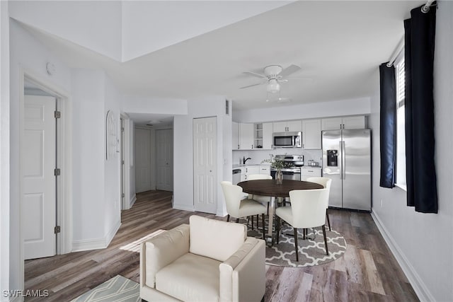 dining space with hardwood / wood-style flooring and ceiling fan