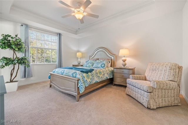 carpeted bedroom featuring a tray ceiling, ceiling fan, and ornamental molding