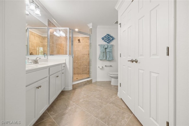 bathroom featuring ornamental molding, vanity, a shower with shower door, and toilet