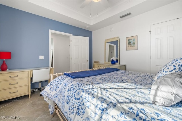 bedroom featuring a raised ceiling, ceiling fan, light tile patterned floors, and ornamental molding