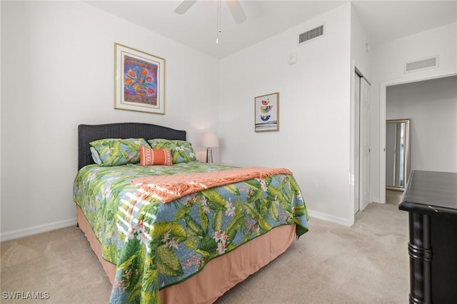 bedroom with ceiling fan, a closet, and light colored carpet