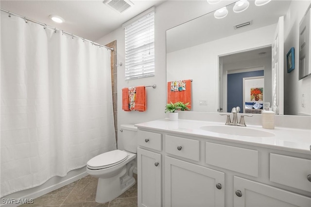 full bathroom featuring tile patterned floors, vanity, toilet, and shower / bath combo with shower curtain