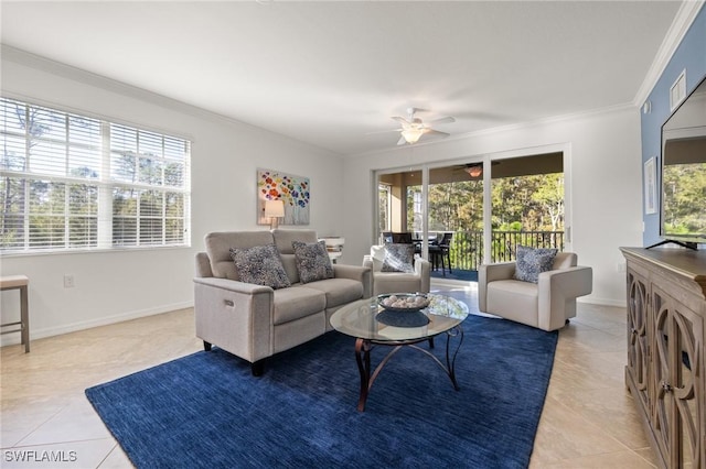 tiled living room featuring plenty of natural light, ceiling fan, and crown molding