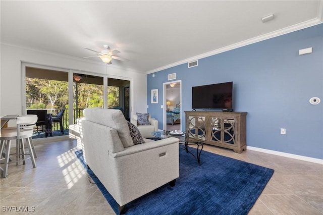 tiled living room with ceiling fan and crown molding