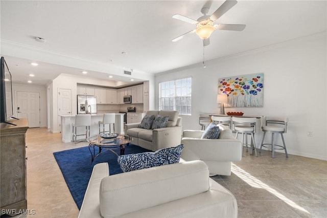 living room featuring ceiling fan, light tile patterned flooring, and crown molding