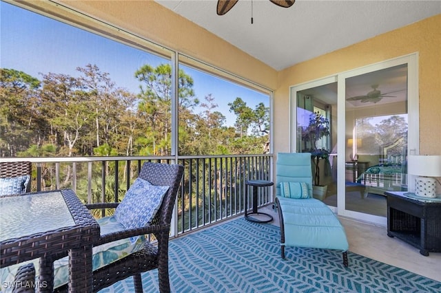 sunroom / solarium featuring ceiling fan