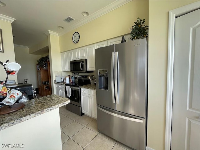 kitchen featuring light stone countertops, appliances with stainless steel finishes, crown molding, white cabinets, and light tile patterned flooring