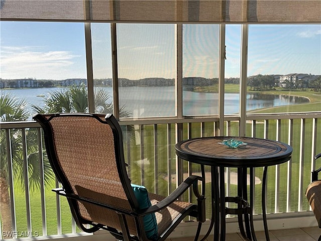 sunroom / solarium with a water view