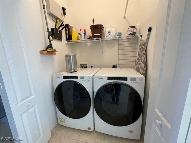 washroom with washer and dryer and light tile patterned floors