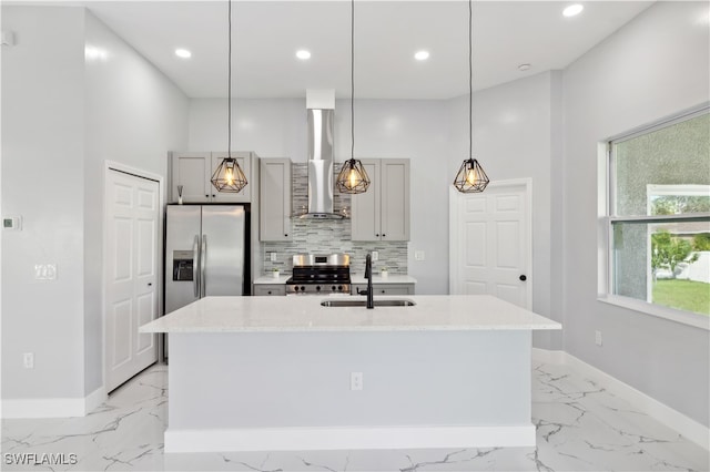 kitchen with stainless steel appliances, gray cabinets, wall chimney exhaust hood, and sink