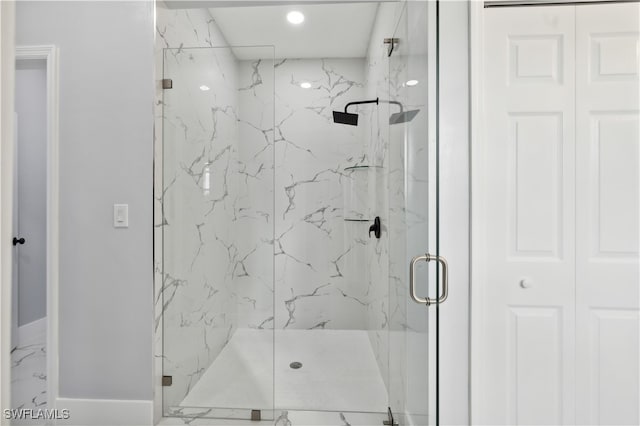 bathroom with a shower with shower door