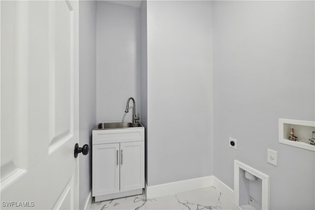 washroom featuring cabinets, hookup for a washing machine, hookup for an electric dryer, and sink