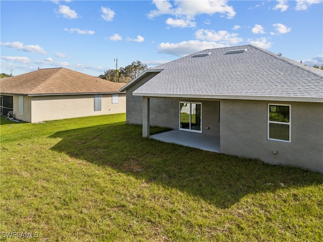 rear view of house with a yard