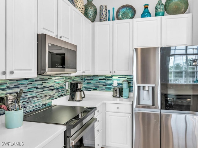 kitchen with appliances with stainless steel finishes, decorative backsplash, and white cabinetry