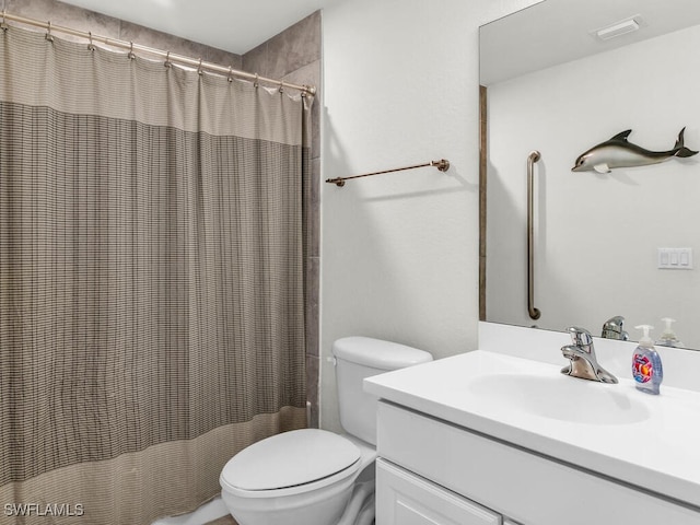 bathroom featuring vanity, toilet, and curtained shower