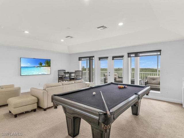 game room with french doors, a raised ceiling, billiards, and light colored carpet