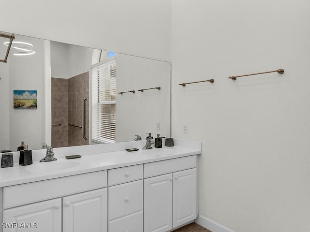 bathroom with vanity and a tile shower