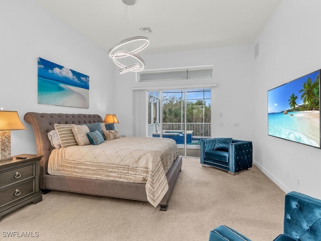 bedroom with a notable chandelier, access to outside, and light colored carpet