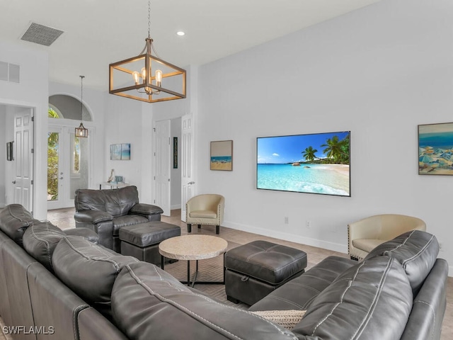 living room with high vaulted ceiling and a chandelier