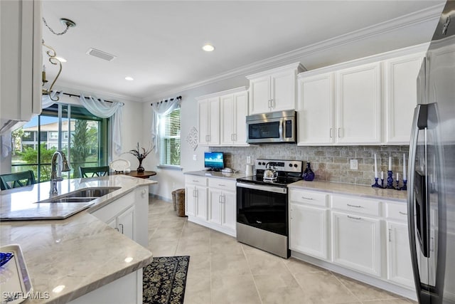 kitchen featuring backsplash, stainless steel appliances, and white cabinets