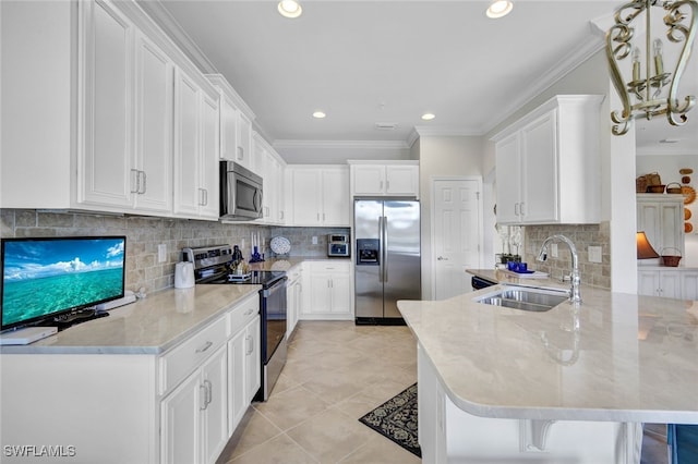 kitchen featuring a breakfast bar, appliances with stainless steel finishes, sink, and white cabinets