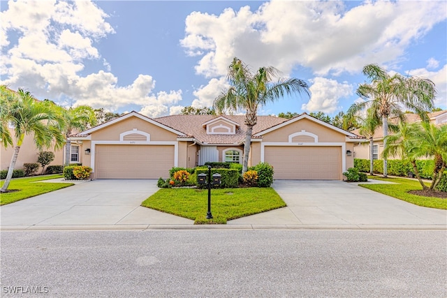 single story home featuring a front yard and a garage