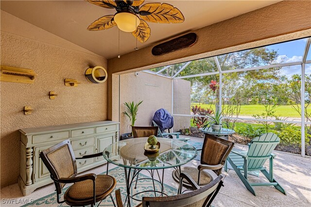 sunroom / solarium featuring lofted ceiling and ceiling fan