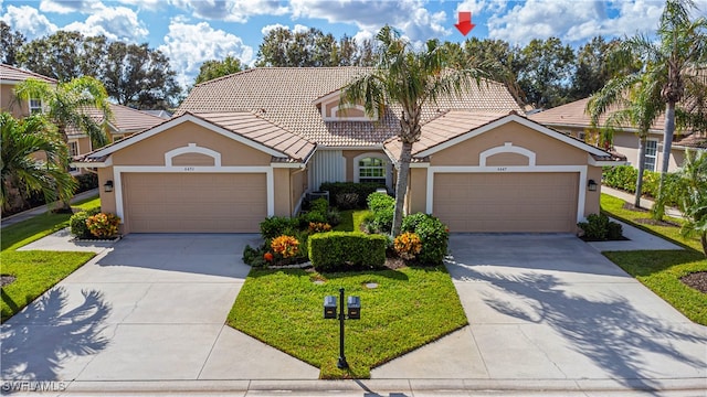 view of front property with a garage and a front lawn