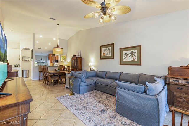 tiled living room featuring lofted ceiling and ceiling fan